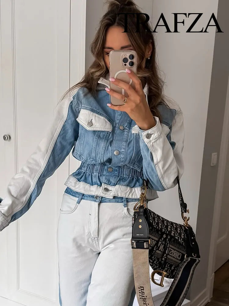 Person wearing a denim jacket and white outfit with a black handbag, standing in front of a white wall. Women’s 2-piece denim jacket and straight jeans set. Patchwork design, mid waist, turn-down collar, button closure, loose casual fit, streetwear.