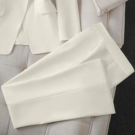 White pants on a light gray surface with a blurred background