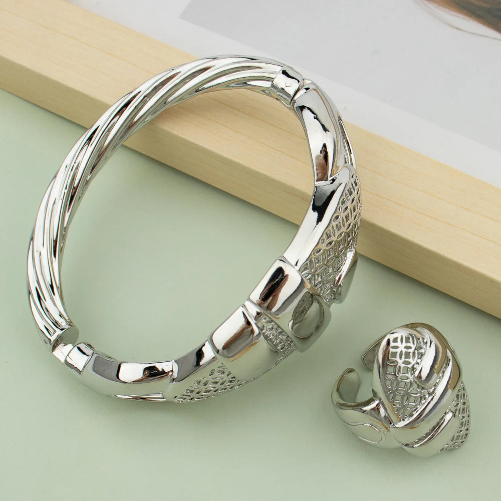 Silver plated cuff bangle and matching ring set with hollow-out geometric design on mint green background