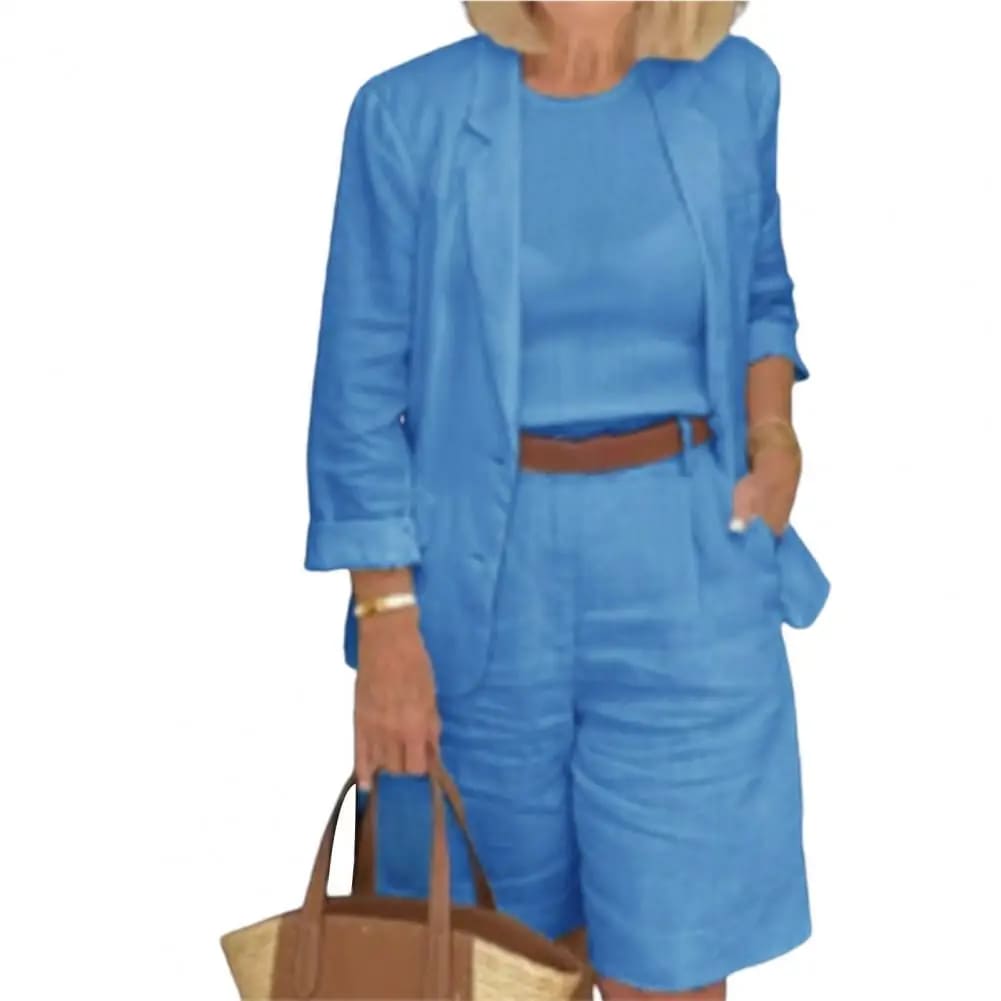 Image of a woman wearing a white Linen Look Blazer and Bermuda Shorts Co-ord Set with a brown belt and straw bag. Ideal smart casual summer outfit.