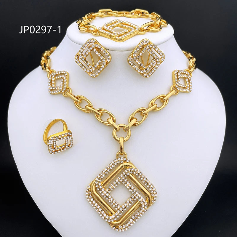 Gold-tone jewelry set displayed on a white jewelry bust, including a necklace with a large square pendant, matching bracelet, earrings, and ring, all featuring rhinestone-like crystal detailing. The set is photographed against a black background with the text 'JP0297-1' in the upper left.