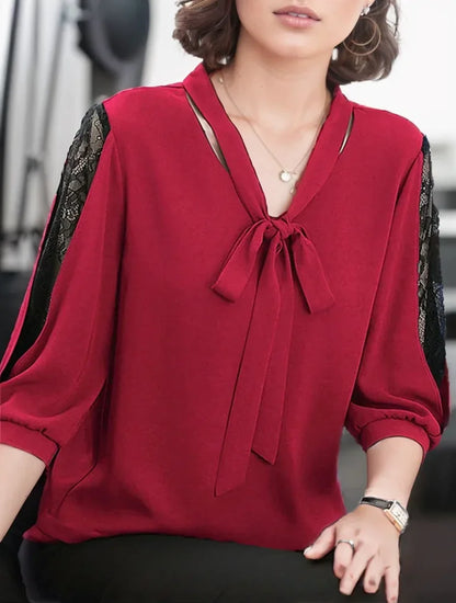 Red blouse with a tie detail worn by a person, blurred background
