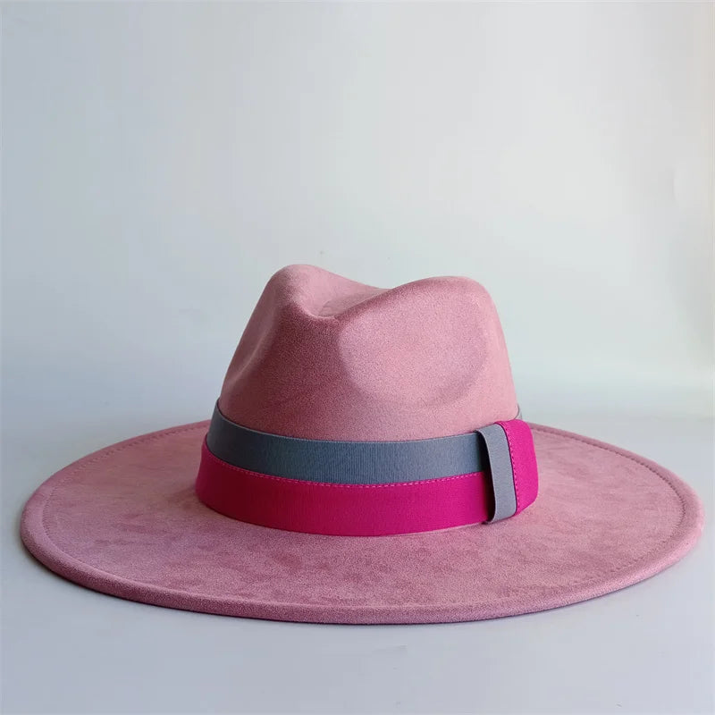 Pink fedora hat with a wide brim and colorful band on a light gray background