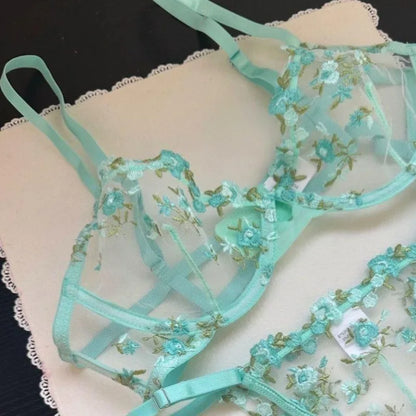Teal floral lingerie set on a dark background