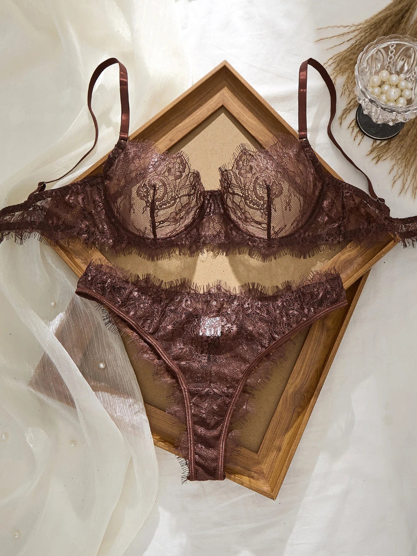 Brown lace lingerie set on a white background