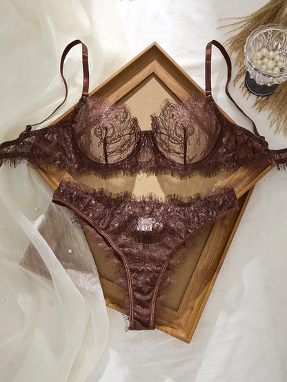 Brown lace lingerie set on a white background