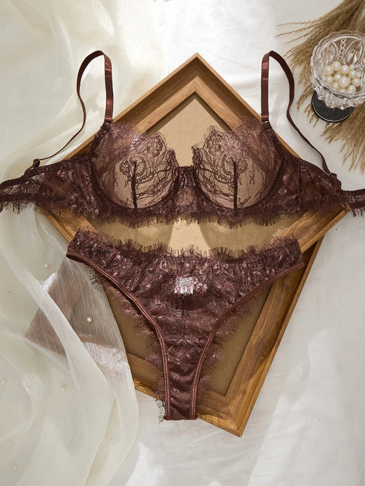 Brown lace lingerie set on a white background