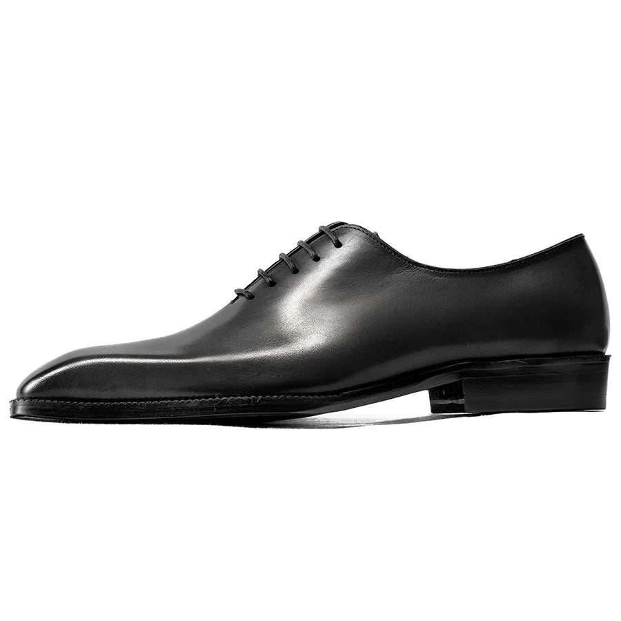 Black leather dress shoe on a white background