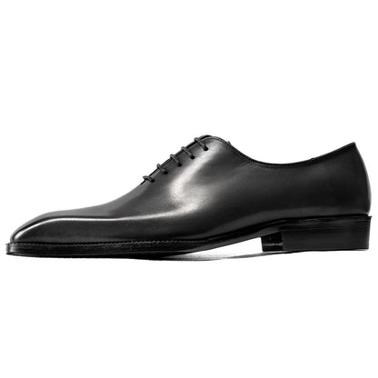 Black leather dress shoe on a white background