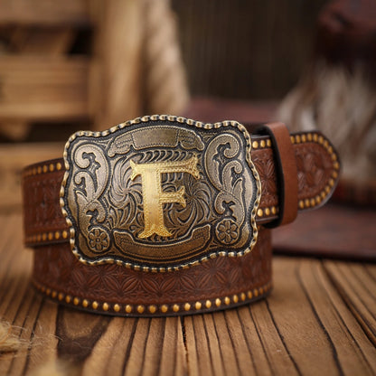 Brown leather belt with a gold and silver buckle on a wooden surface