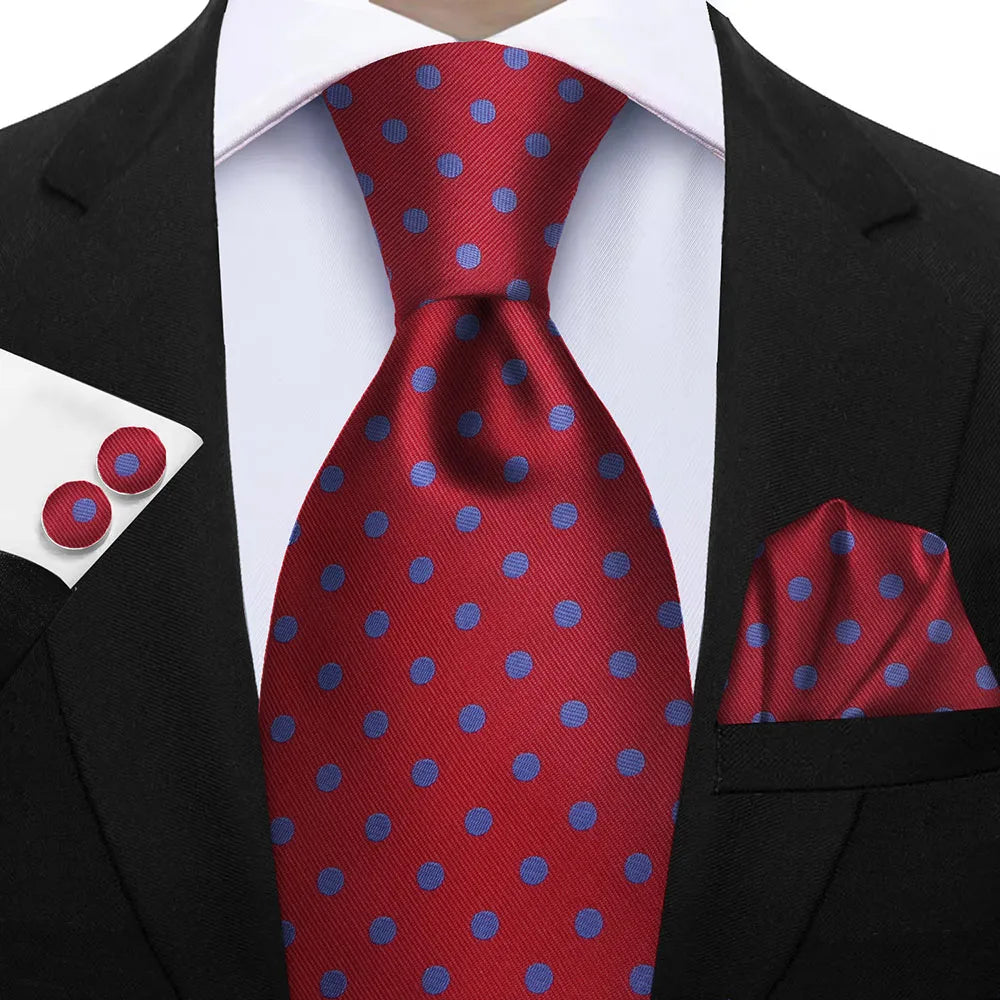 Red tie with blue polka dots paired with a black suit, white shirt, and matching pocket square. Elegant men’s 3-piece tie set: striped necktie, floral pocket square, matching cufflinks. Fashionable polyester accessories for formal occasions.