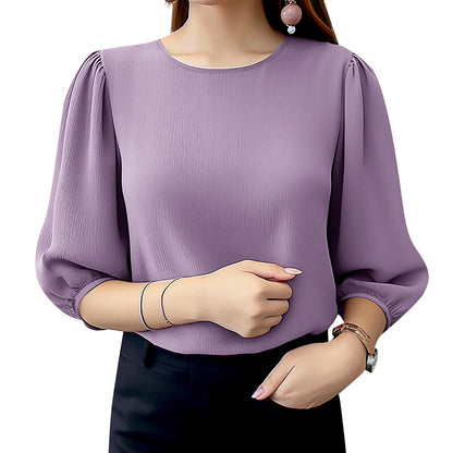 Purple blouse with puffed sleeves worn by a person on a white background