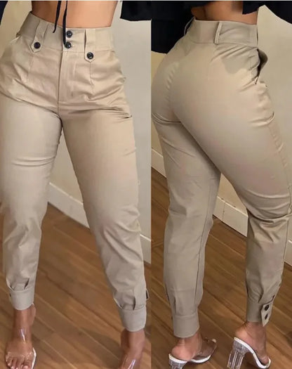 Beige pants worn by a person on a wooden floor.