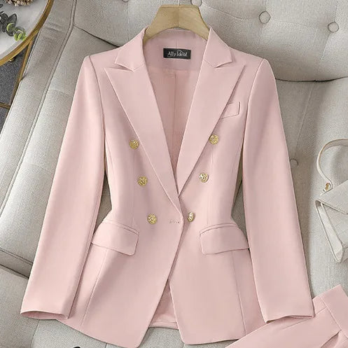 Pink blazer with gold buttons on a light gray sofa
