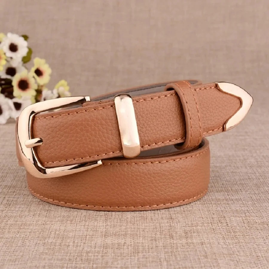 Brown leather belt with gold buckle on a textured surface. Women’s vintage white leather trouser belt with solid pin buckle. Stylish, high-quality accessory for fashion-forward looks, UK.