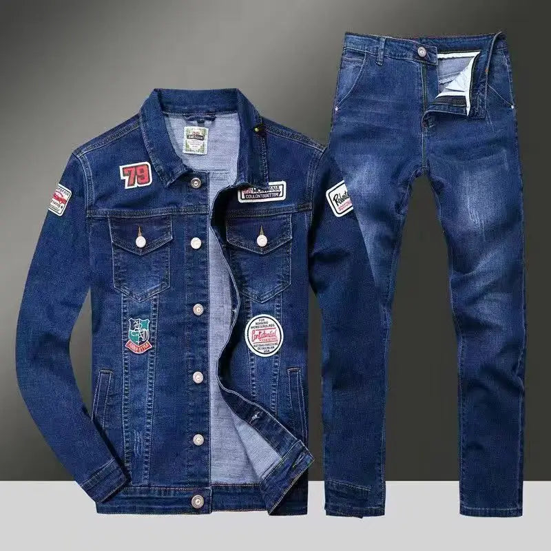 Blue denim jacket and jeans set with patches on a gray background