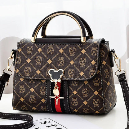 Designer handbag with a distinctive pattern and decorative charm on a white background
