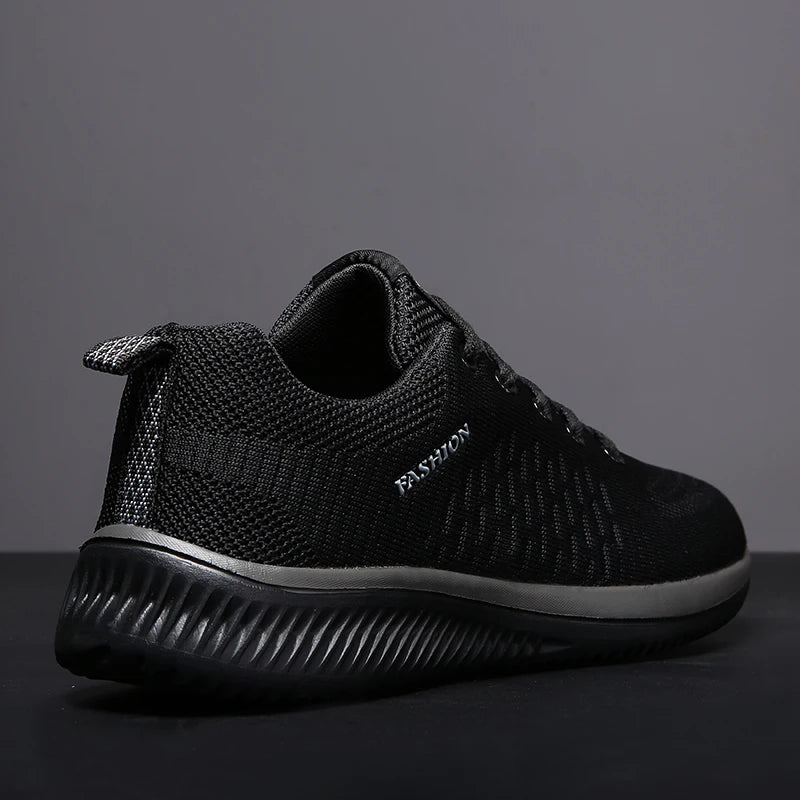 Black sneaker with 'FASHION' text on a gray background. Men’s breathable running sneakers with mesh lining, PU insole, EVA outsole, lightweight casual sports shoes, perfect for jogging and walking.