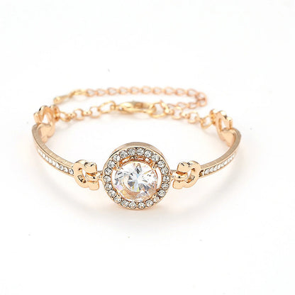 Gold bangle bracelet encrusted with clear crystals