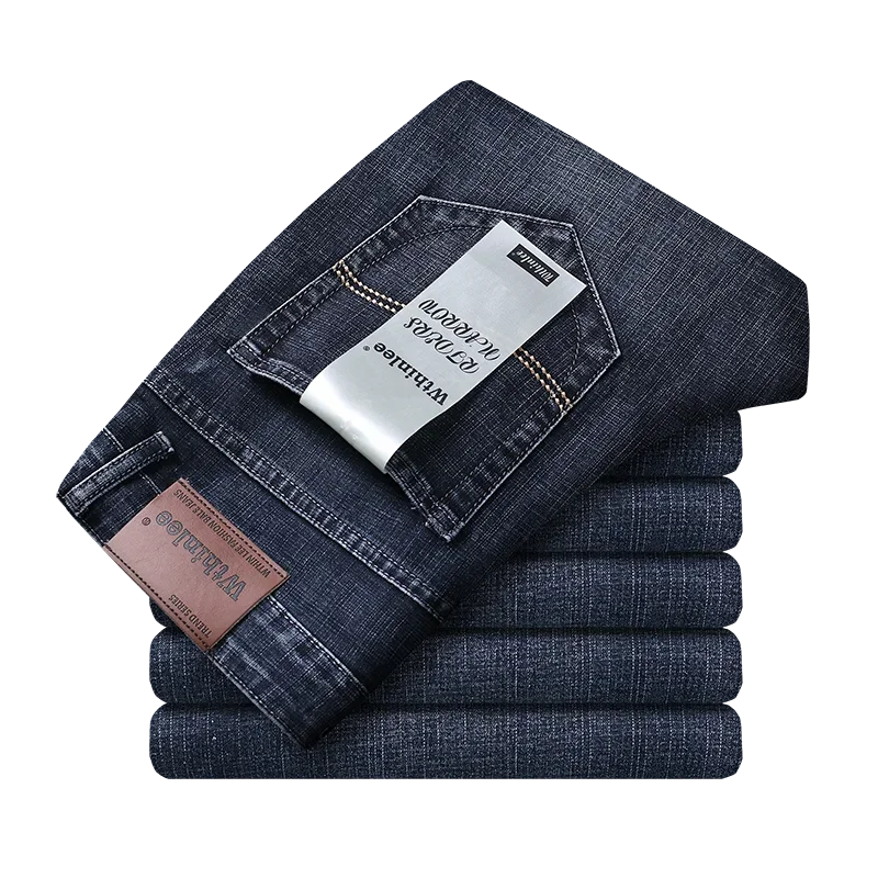 A pair of men's straight-leg blue jeans with a tag visible on the waistband. Smart casual business men’s jeans, slim straight fit, zipper fly, midweight denim, blue/black, office-ready — WTHINLEE UK exclusive.