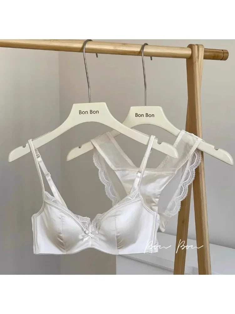 White lace bra on a hanger with 'Bon Bon' branding against a neutral background