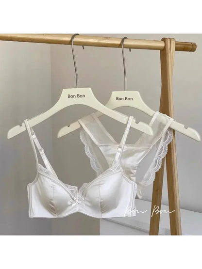 White lace bra on a hanger with 'Bon Bon' branding against a neutral background