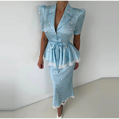 Light blue dress with floral pattern worn by a person against a white background