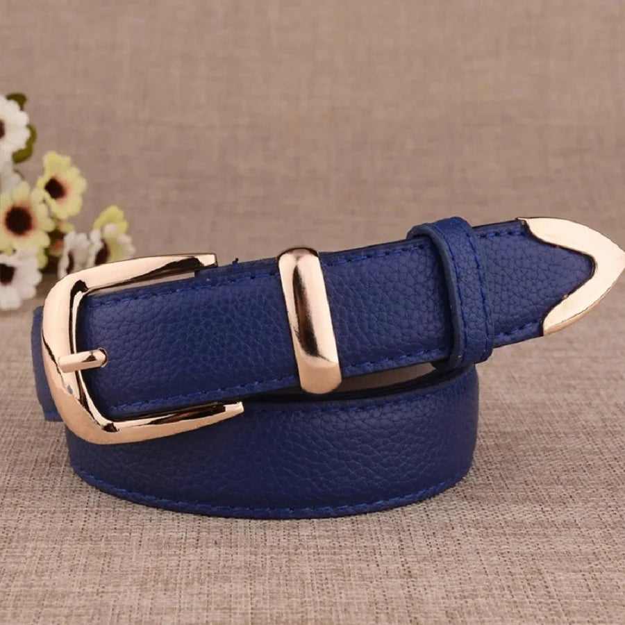 Blue leather belt with gold buckle on a textured surface. Women’s vintage white leather trouser belt with solid pin buckle. Stylish, high-quality accessory for fashion-forward looks, UK.
