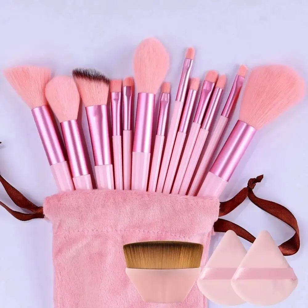 Set of pink makeup brushes with a pink holder on a white background. Soft fluffy makeup brush set with wool fiber bristles and plastic handles. Complete set for powder, foundation, eyeshadow, and beauty blending.