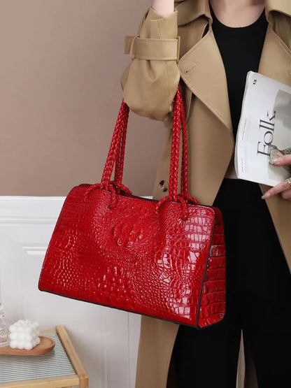 Person holding a red textured handbag with a neutral . Luxury women’s tote bag in genuine red crocodile leather. Large capacity, stylish handle, fashion travel handbag. Perfect for shoulder or portable use UK.