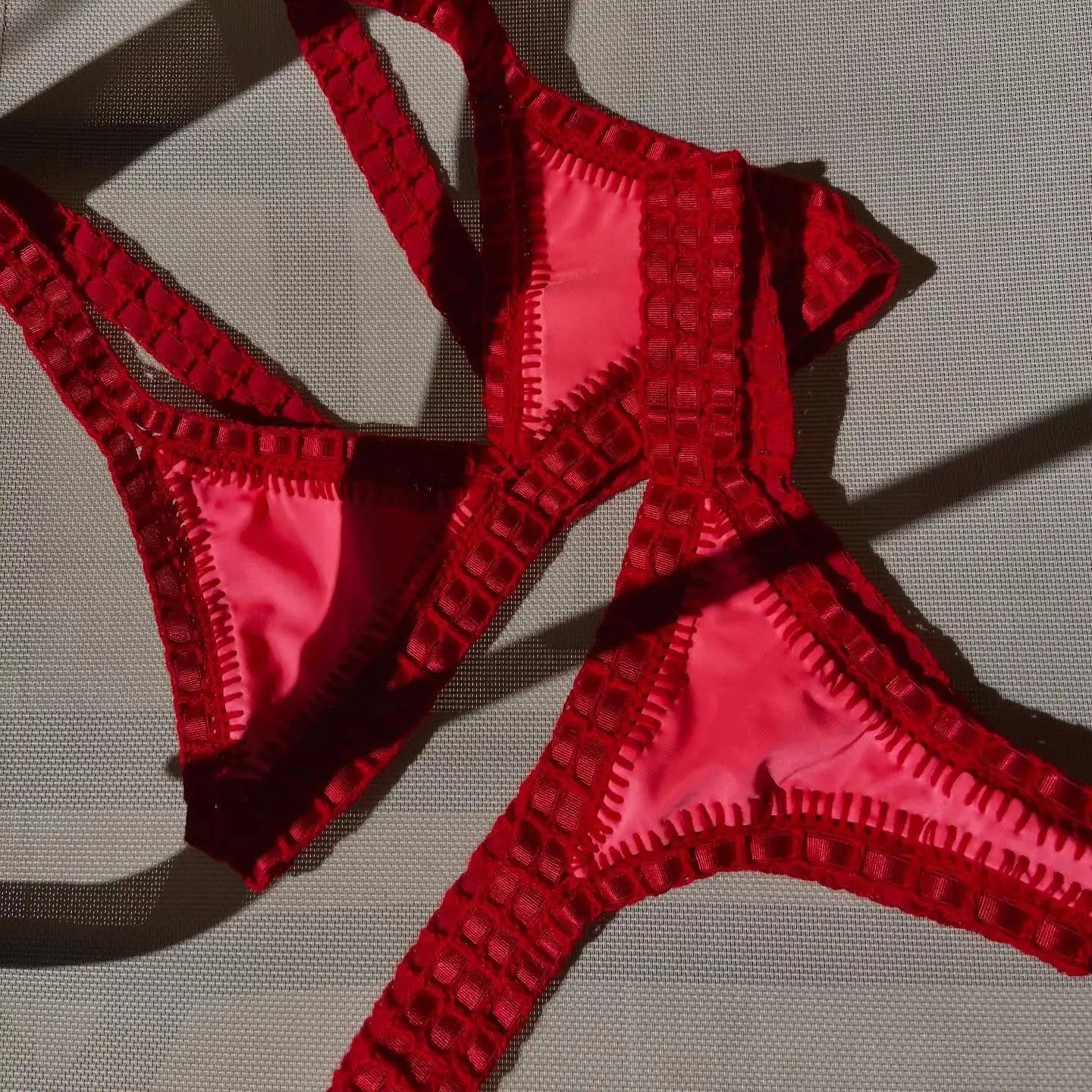 Red triangle bikini set flat lay — Brazilian cut swimwear women