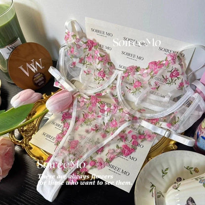 Floral-patterned face masks with branding on a decorative surface.