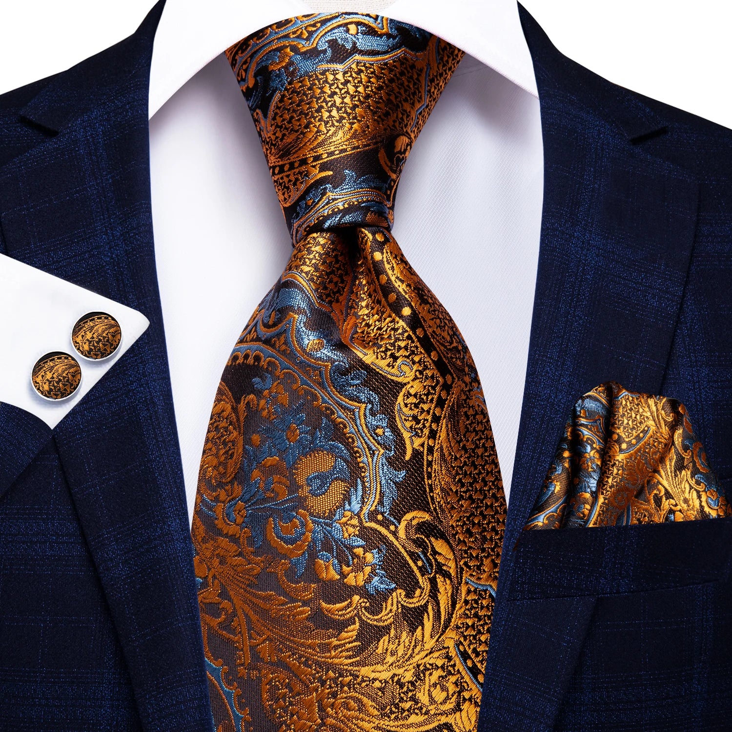 Navy suit with gold and blue paisley tie, pocket square, and cufflinks on a white background. Men’s luxury paisley silk tie and pocket square set, 8.5cm wide, for business or wedding. Red formal necktie, ftf fashion UK.