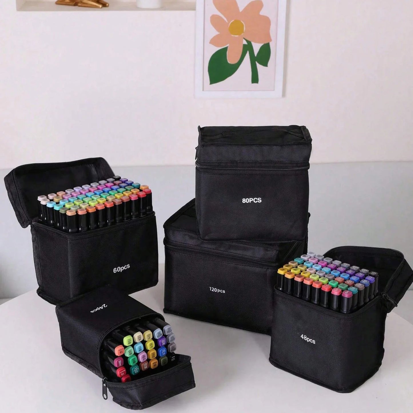 Set of black carrying cases with colorful markers on a white surface. Pro Dual-Tip Alcohol Markers Set featuring fine and chisel tips, vibrant streak-free ink, ergonomic design for artists’ coloring and sketching projects UK.