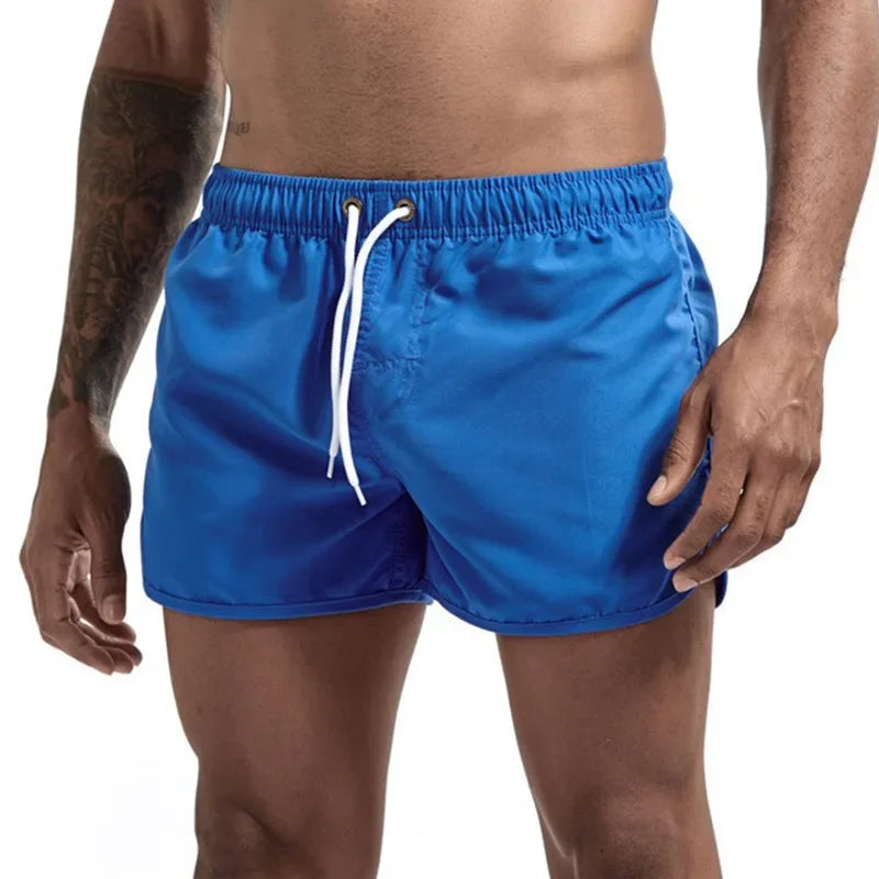 Men's deep blue quick-drying swimming trunks in vibrant colors for beach and surfing