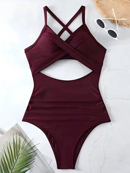 Maroon swimsuit with cutout design on a light background