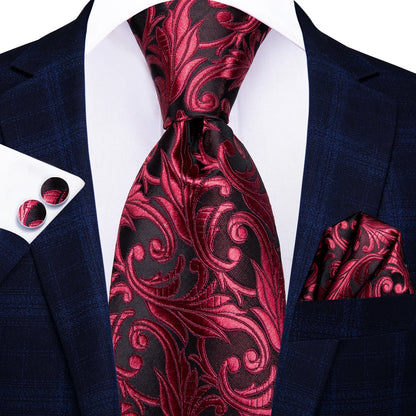 Red and black patterned tie with matching pocket square and cufflinks on a navy suit. Men’s luxury paisley silk tie and pocket square set, 8.5cm wide, for business or wedding. Red formal necktie, ftf fashion UK.