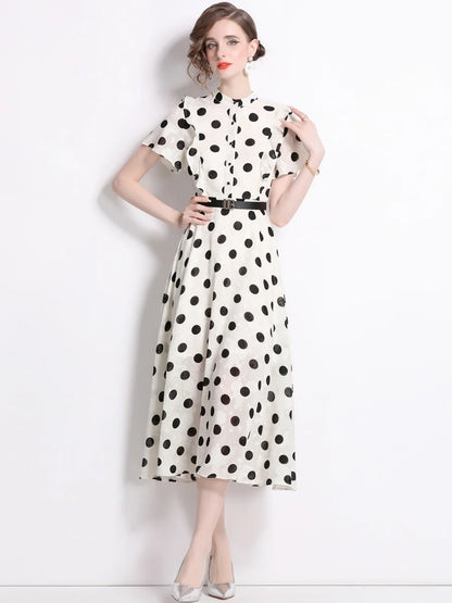 A woman wearing an elegant polka dot dress