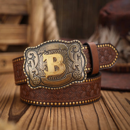 Brown leather belt with a decorative buckle featuring a gold 'B' on a wooden surface.