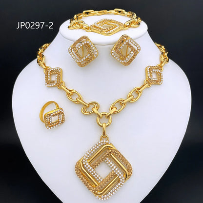 Gold jewelry set displayed on a white neck bust, including a necklace with a large square pendant, matching bracelet, earrings, and ring, all featuring gold-tone metal and clear rhinestone detailing. The text 'JP0297-2' appears in the upper left on a black background.