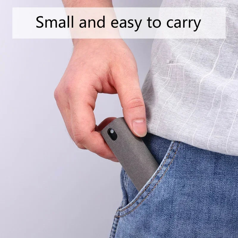 Hand holding a small gray device, likely a phone case, with text 'Small and easy to carry' on a light gray background. 4in1 microfiber screen cleaner spray with cloth for phones, tablets, computers, glasses. Portable, streak-free, safe for all screens, UK FTF Market.