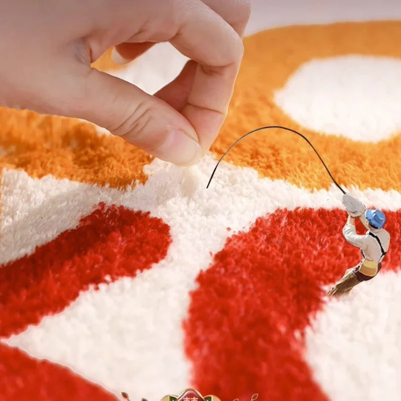 Small figure of a climber on a textured surface with a hand interacting with it. Round plush red carpet, soft and thick. Machine-woven, washable, ideal for living room, bedroom, cloakroom. Modern style UK home décor.