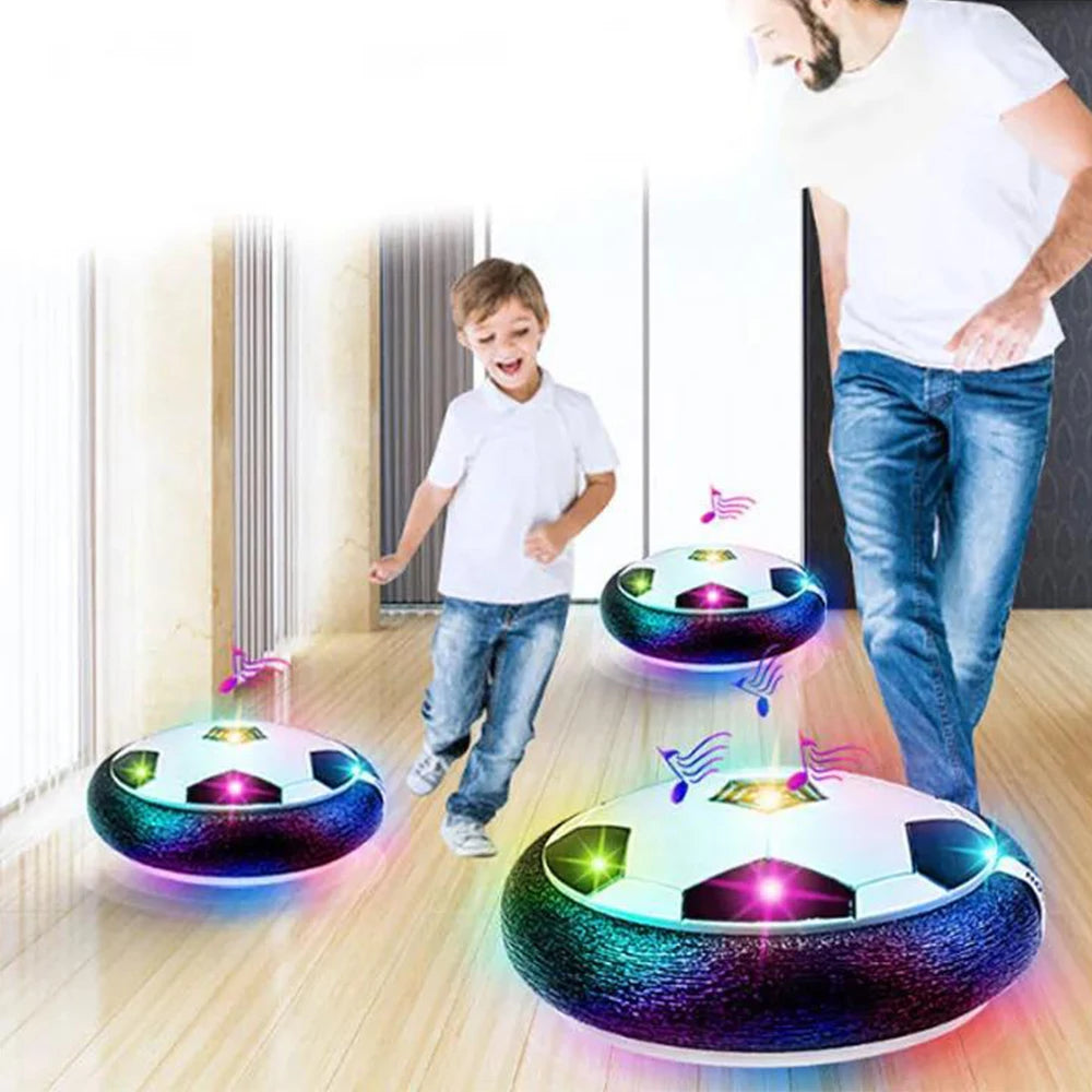 Children playing with glowing soccer ball toys on a wooden floor. LED hover soccer ball toy, safe electric floating football for kids. Music, unisex, gift idea, indoor/outdoor, UK delivery ftf fashion.