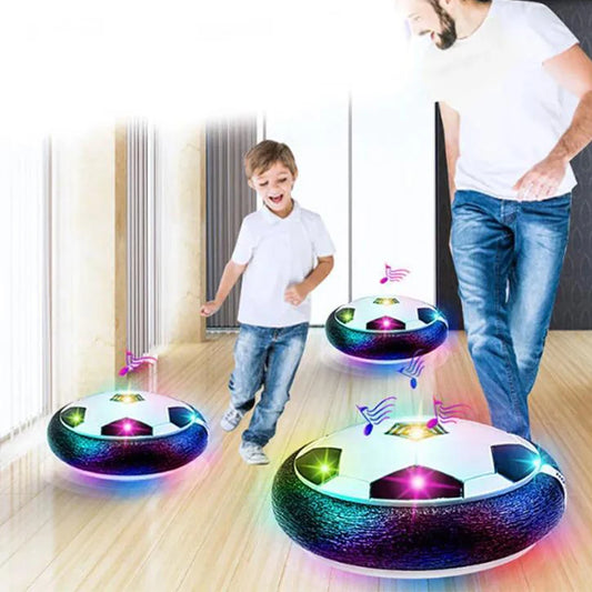 Children playing with glowing soccer ball toys on a wooden floor. LED hover soccer ball toy, safe electric floating football for kids. Music, unisex, gift idea, indoor/outdoor, UK delivery ftf fashion.