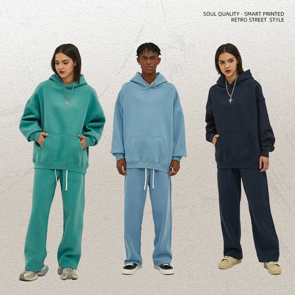 Three people wearing teal, blue, and navy tracksuits against a light gray background.