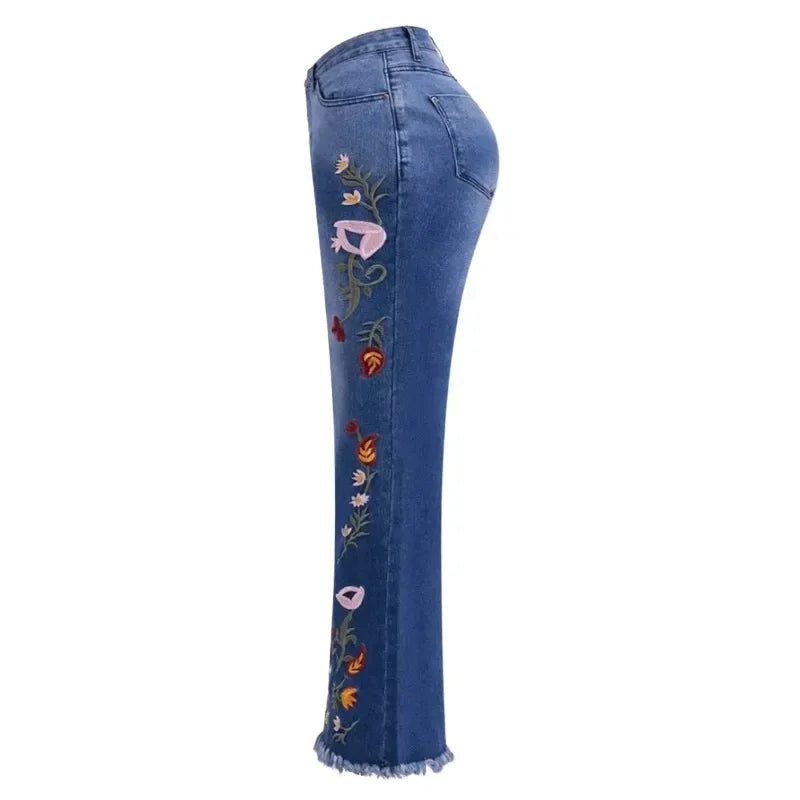 Side view of women's flare jeans with colourful floral embroidery detail along the leg