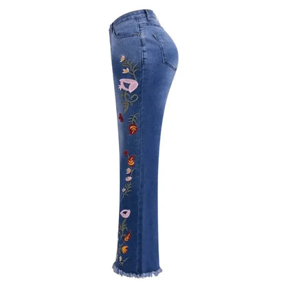 Side view of women's flare jeans with colourful floral embroidery detail along the leg