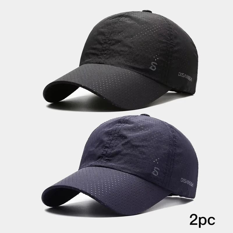 Two black and navy baseball caps on a light gray background