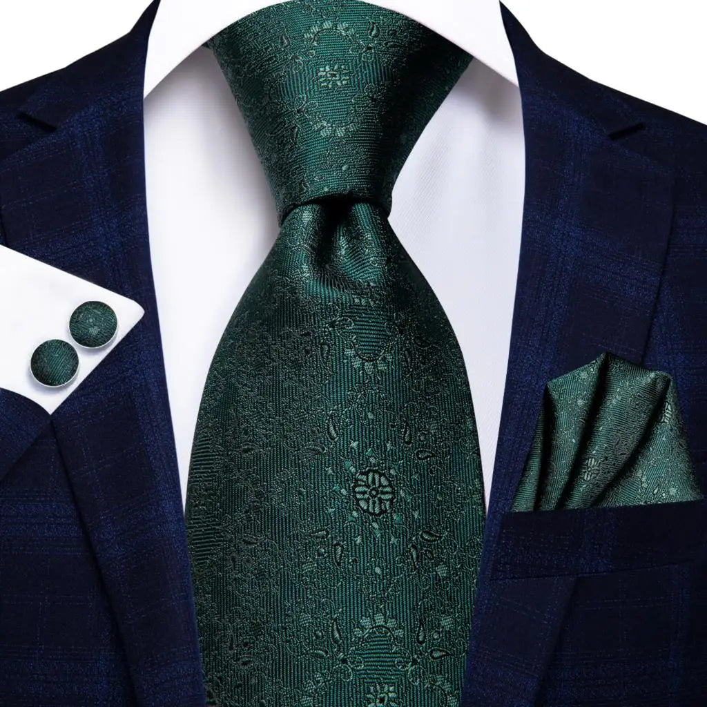 Green tie, pocket square, and cufflinks set with a navy suit on a white background. Men’s luxury paisley silk tie and pocket square set, 8.5cm wide, for business or wedding. Red formal necktie, ftf fashion UK.