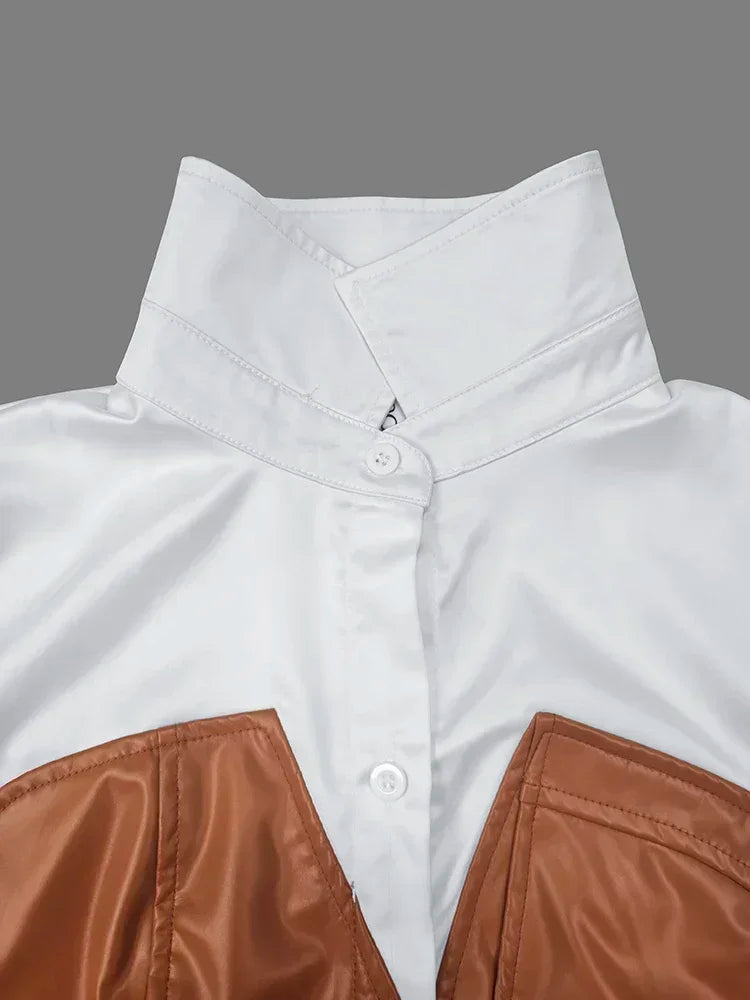 Close-up of a white shirt with brown accents on a gray background